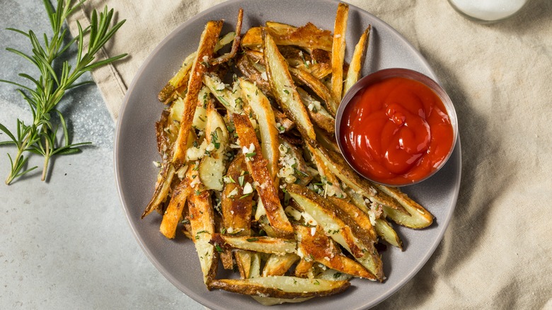 Plate of garlic Parmesan fries with side of ketchup