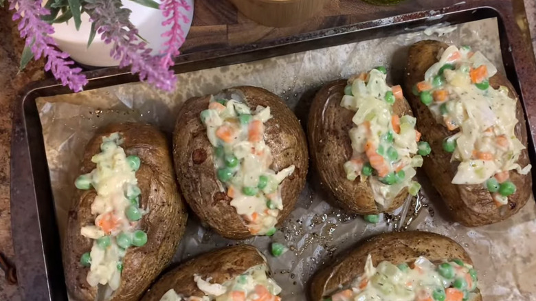 chicken pot pie filled baked potatoes served on baking tray