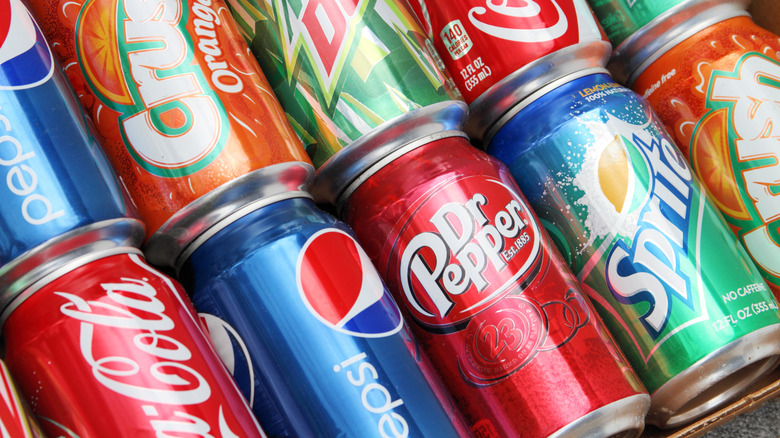 Two rows of soda cans lay one on top of the other