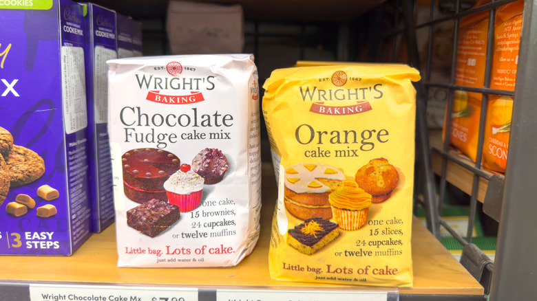 Packages of cake mix sit on a store shelf
