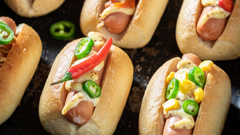 Hot dog sliders with chili, jalapeño, and corn topping