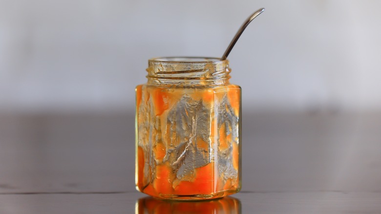 a nearly-empty jar of apricot jam