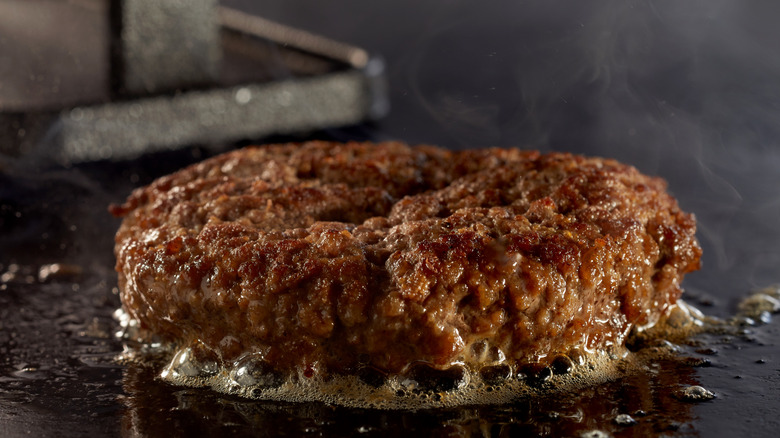 burger cooking on griddle