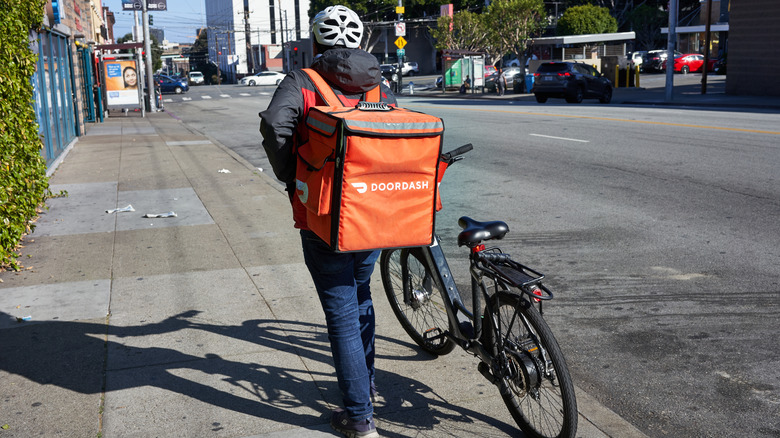 DoorDash food delivery worker with bike