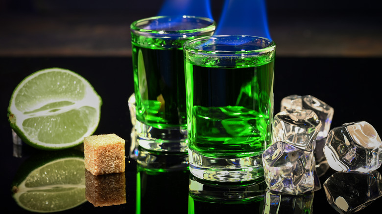 Two shot glasses of absinthe set on fire