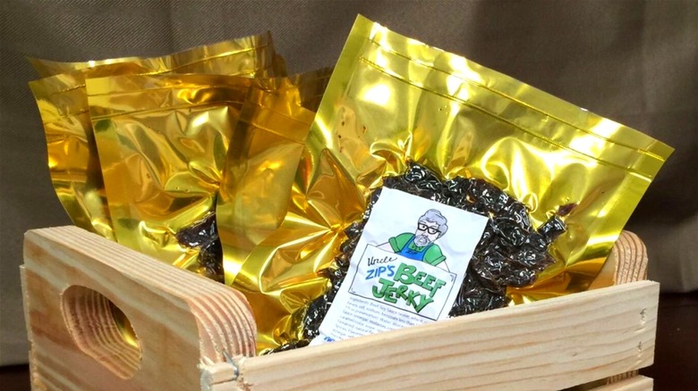 Packages of Uncle Zip's Beef Jerky in a wooden crate