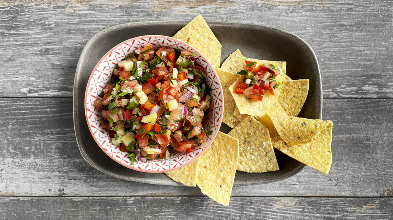 Tortilla chips and salsa on wood table
