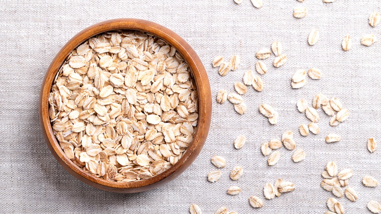 Rolled oats on linen background
