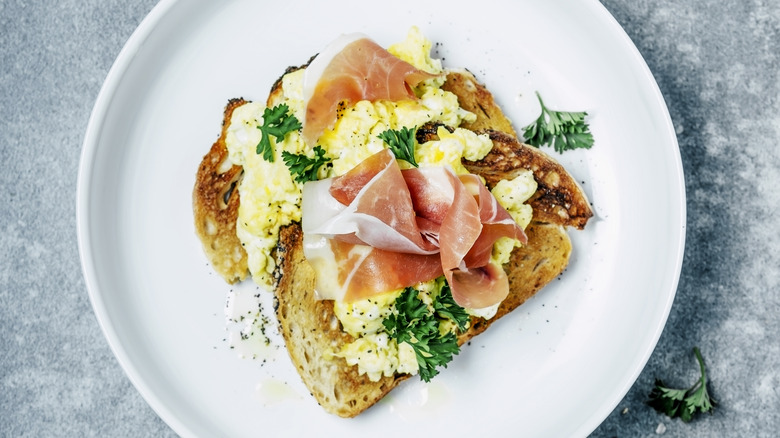 Prosciutto on scrambled eggs and bread