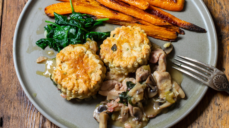 chicken cobbler on a plate with a side of carrots