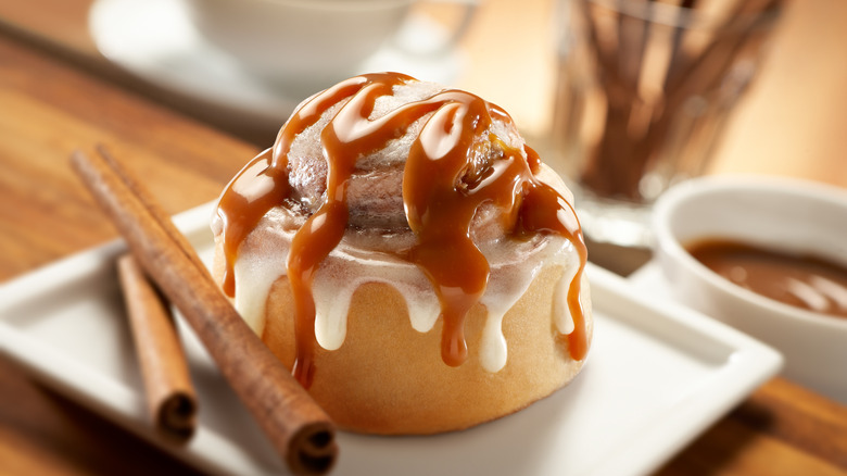 Cinnamon roll with caramel drizzle and frosting