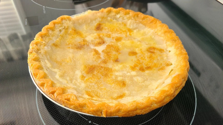 A water pie sits on a stove top.