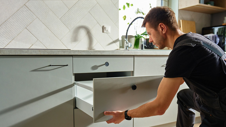 man assembling kitchen cabinet