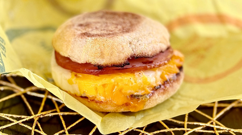 An Egg McMuffin sitting atop its wrapper.