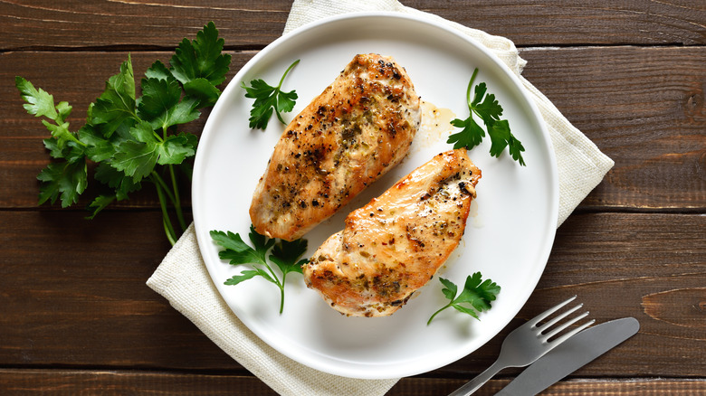 Baked chicken breasts garnished with herbs