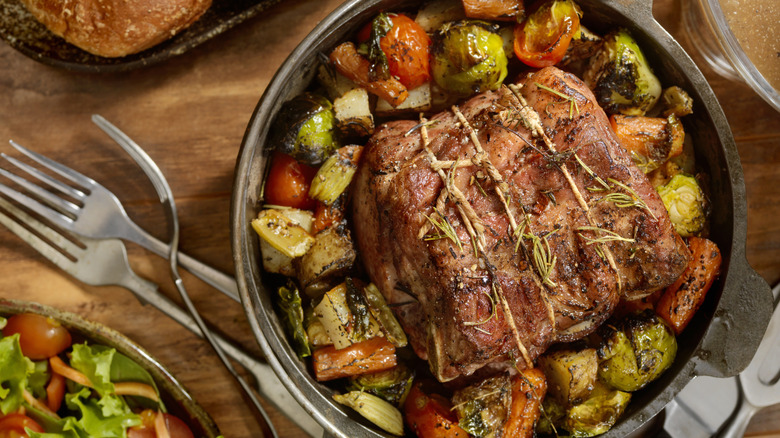 Roast with herbs and root vegetables in a pot