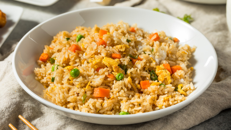 White bowl of egg and vegetable fried rice