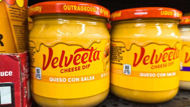 Two jars of Velveeta cheese dip.