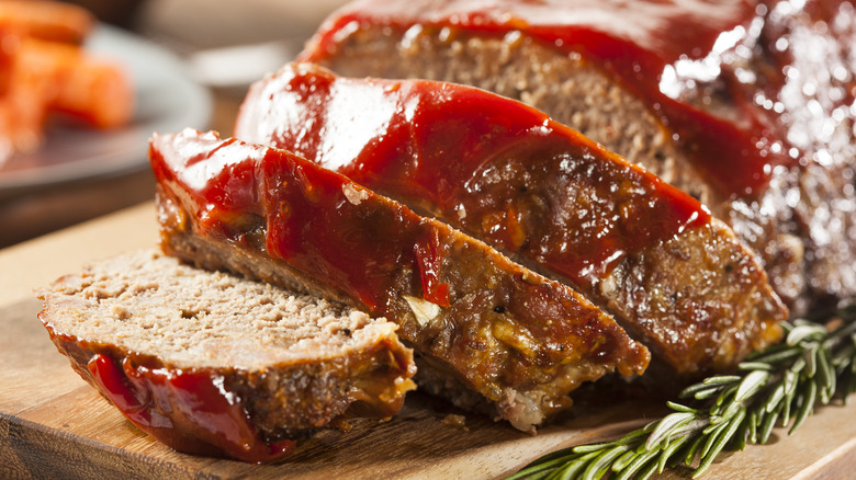 sliced meatloaf topped with red sauce