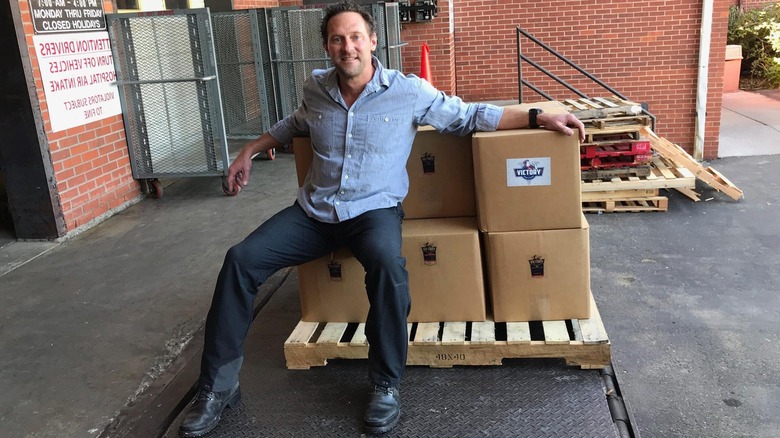 Victory Coffees founder Cade Courtley with boxes of coffee