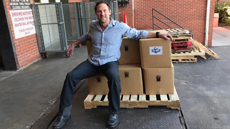 Victory Coffees founder Cade Courtley with boxes of coffee