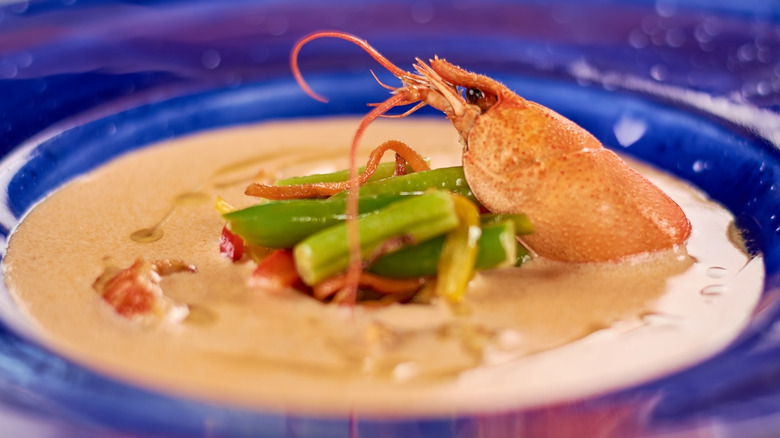 Creamy crawfish soup served with a crawfish on top
