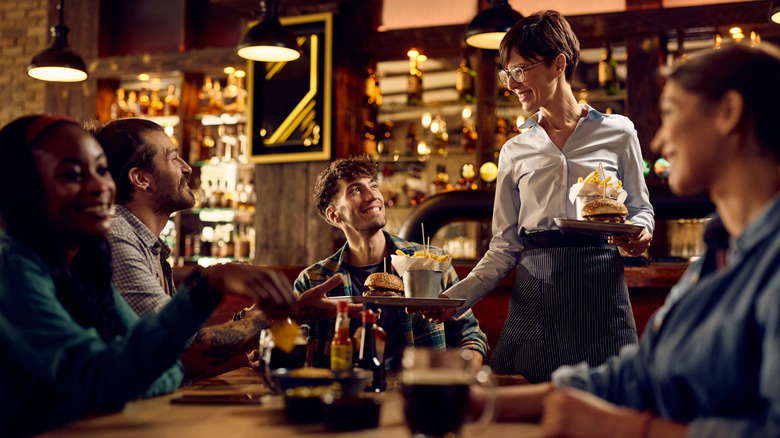 guests enjoying food at a bar
