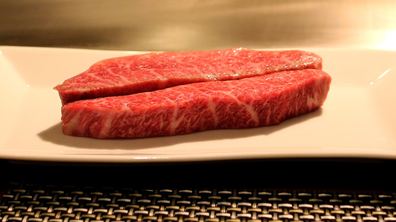 Kobe beef strips on a white plate