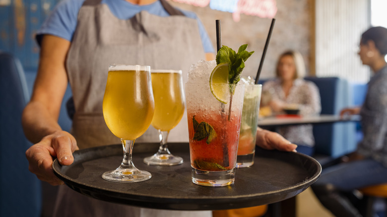 young woman carrying drinks