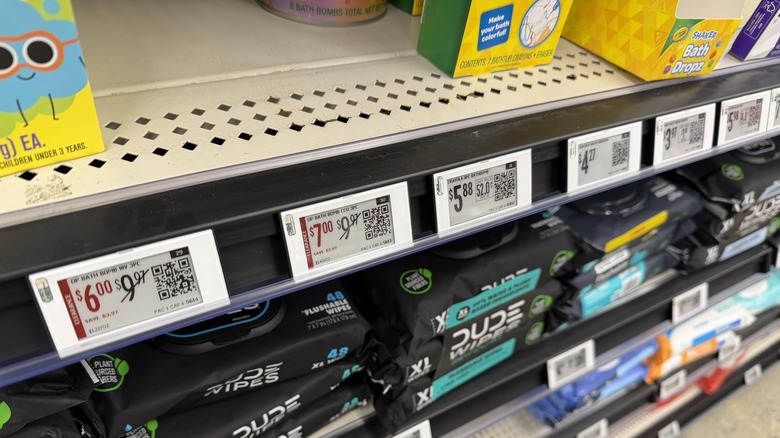Digital shelf labels line a Walmart shelf.