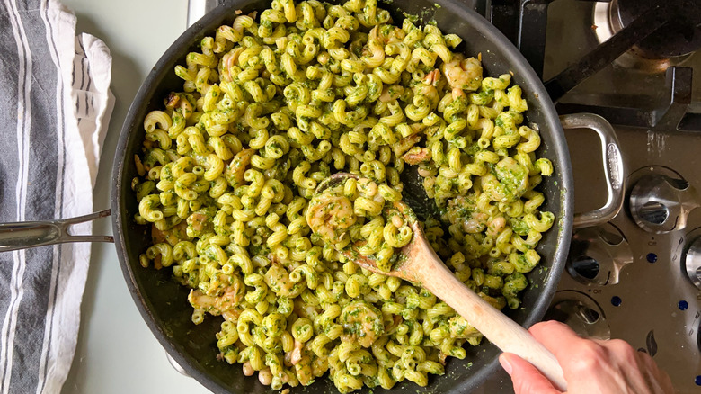 Walnut pesto pasta with shrimp in skillet