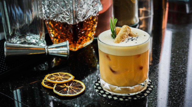 coffee cocktail with a coconut roll garnish.