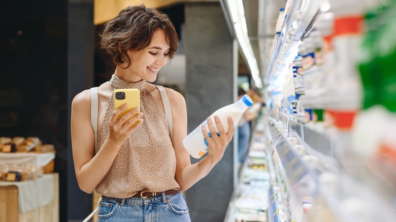 woman reading milk label