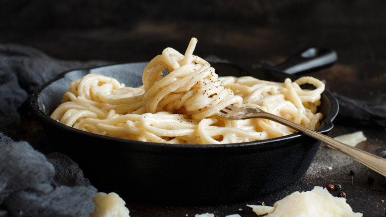 a cast iron pan with lightly sauced cacio e pepe, or noodles with cheese and pepper.