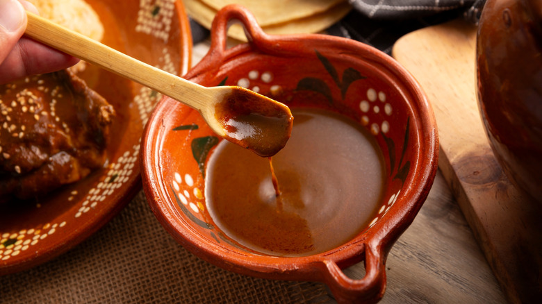 mole poblano in bowl with spoon to demonstrate texture