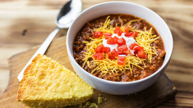chili with cheese, sour cream, peppers, and cornbread