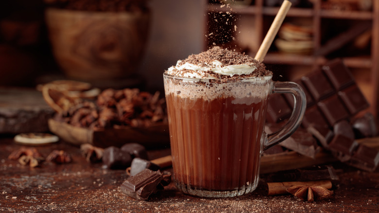 fancy hot chocolate surrounded by chocolate