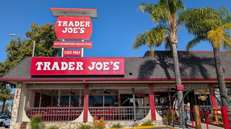 A Trader Joes grocery store with palm trees outside
