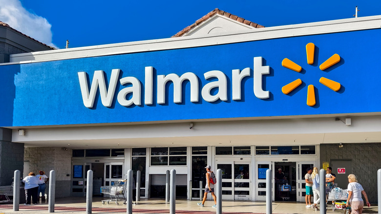 Exterior of a Walmart store with people out front