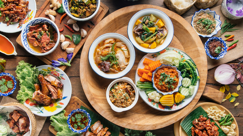 Various Thai dishes and ingredients on a table