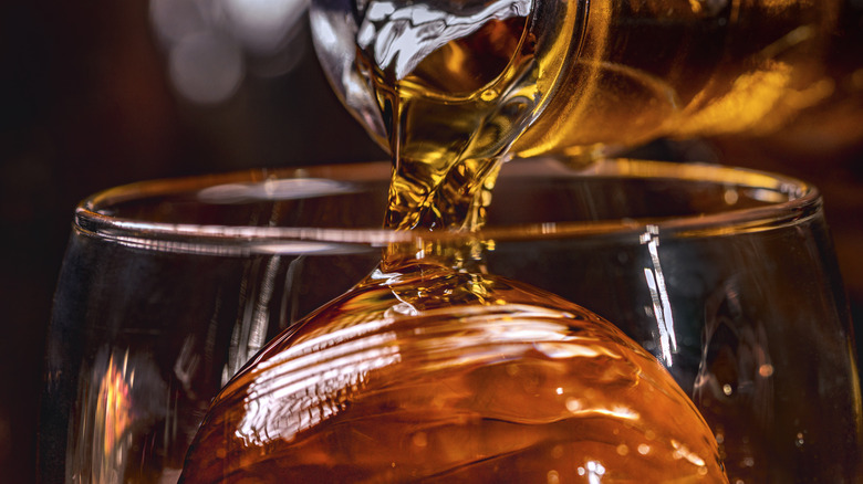 Whiskey being poured into rocks glass