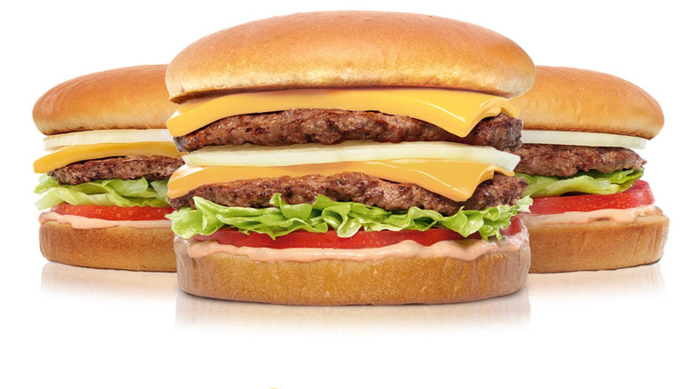 In-N-Out Burger Double Double flanked by one cheeseburger and one hamburger.