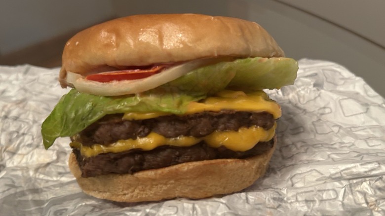 Wendy's Dave's Burger sitting on wrapping.