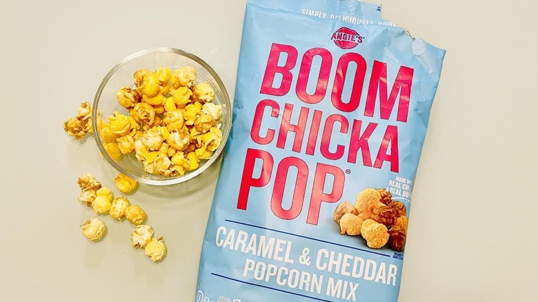 Photo of Angie's Boom Chicka Pops Caramel & Cheddar Popcorn torn open and in a snacking bowl