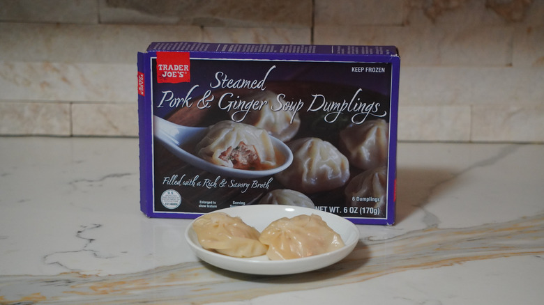 Trader Joe's Steamed Pork & Ginger Soup Dumplings on a marble countertop.