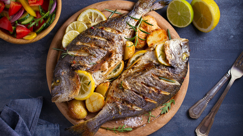 roasted fishes on wooden plate