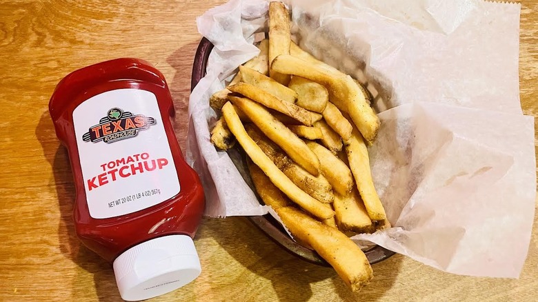 Texas Roadhouse's side of Steak Fries with a bottle of ketchup