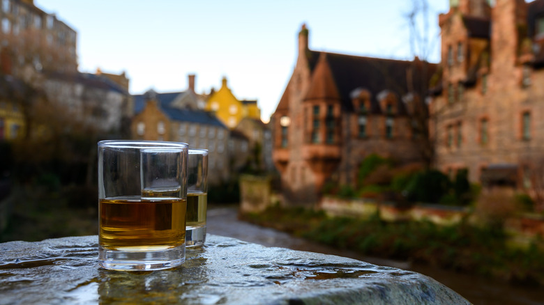 Two glasses of Scotch with Edinburgh in background