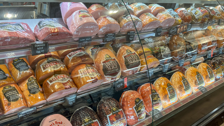 Packaged deli meats displayed inside a deli counter