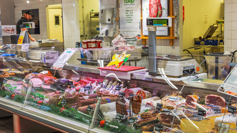 A deli counter with various processed meats